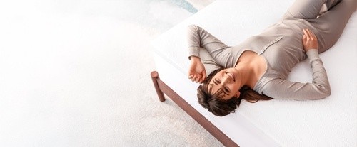 woman laying on mattress topper