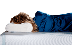 Woman laying on Tempur-neck pillow on a Tempur-Pedic mattress